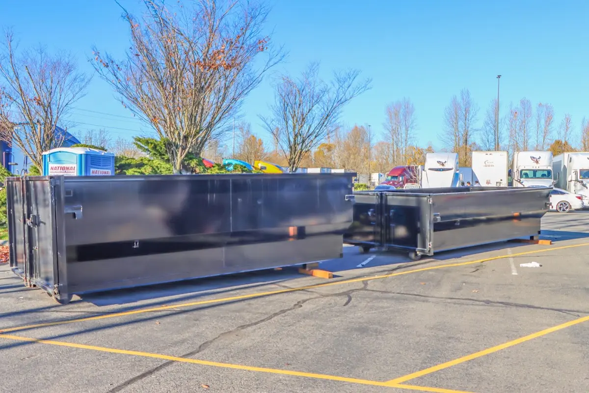 Professional dumpster rental service with roll-off container on residential driveway in Catalina